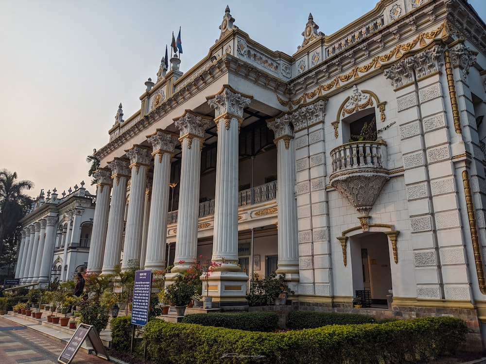 a building with columns and a clock on the front of it