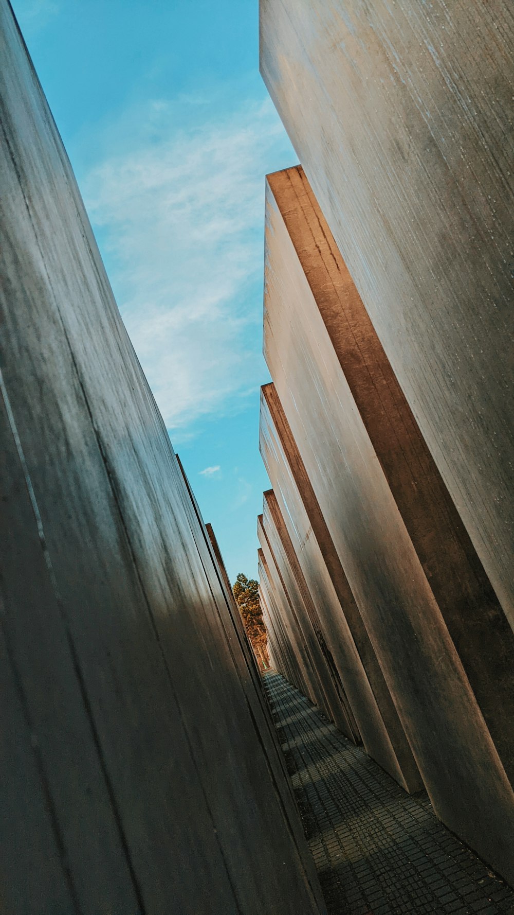 a row of concrete pillars with a blue sky in the background