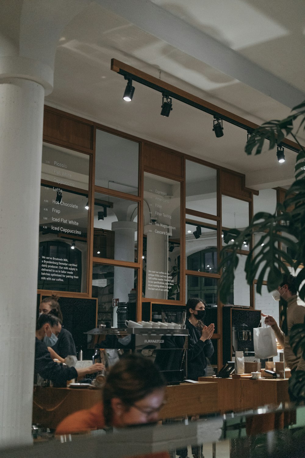 a group of people sitting at a table in a restaurant