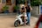 A group of female bikers gathered around their motorcycles, smiling and enjoying the moment.