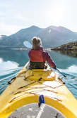 a person in a kayak paddling on the water