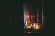 A cozy nook with plush cushions and a flickering candle, inviting quiet reflection.
