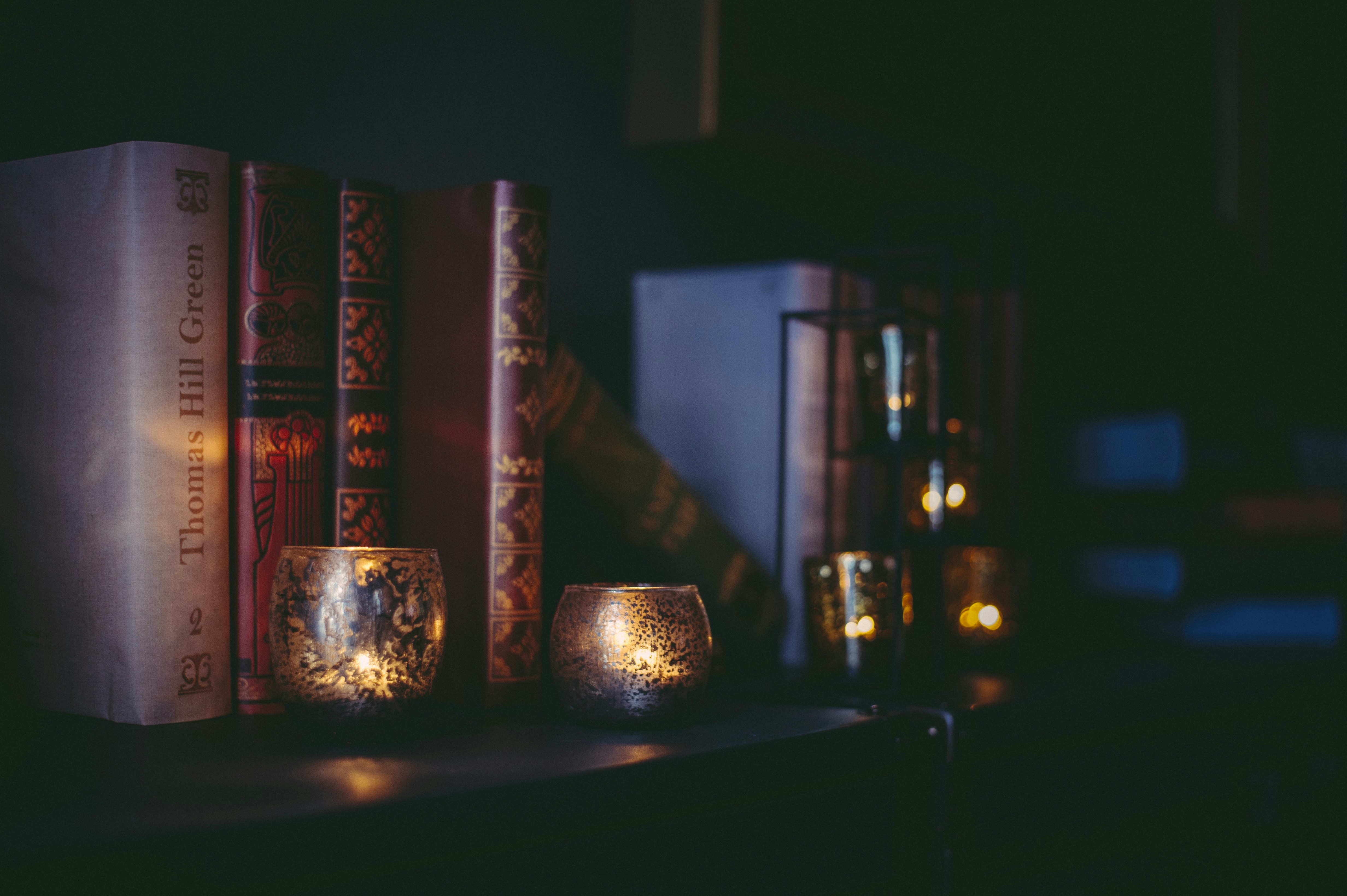 a couple of candles sitting on top of a book shelf, Decorating in fairy tale style.