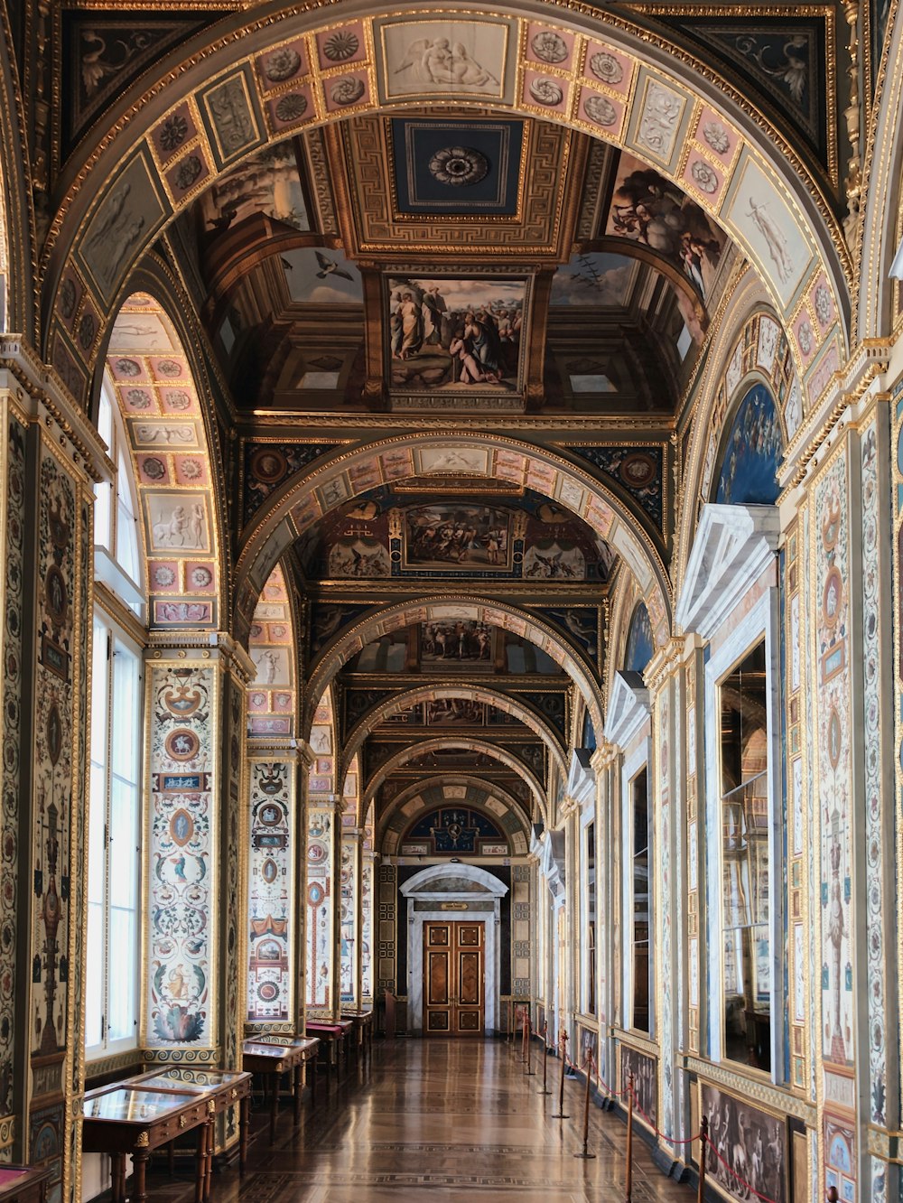 a long hallway with many paintings on the walls