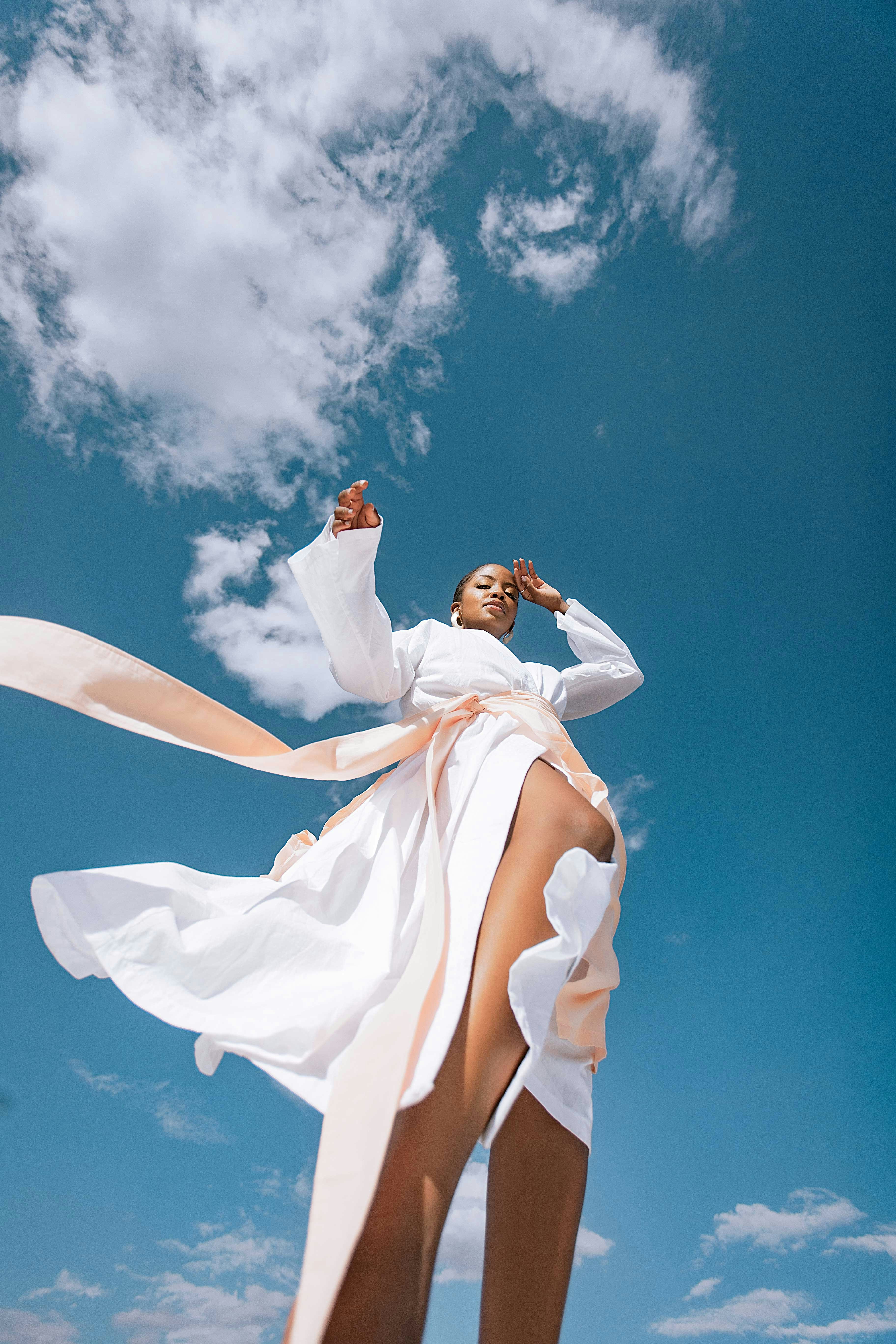 A woman in a white dress flying through the air