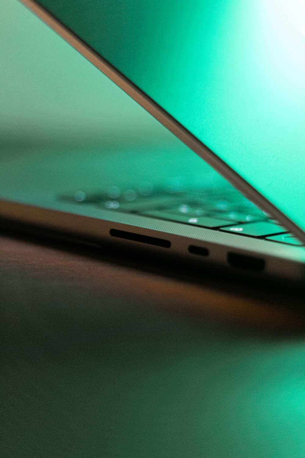 a close up of a green laptop on a table