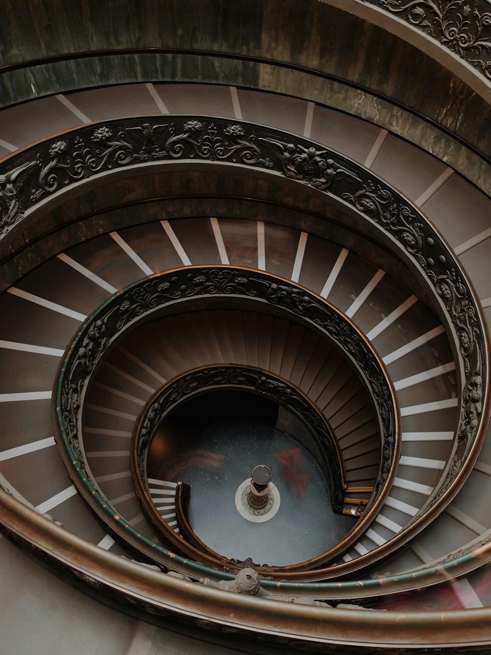 a spiral staircase in a building with metal railings