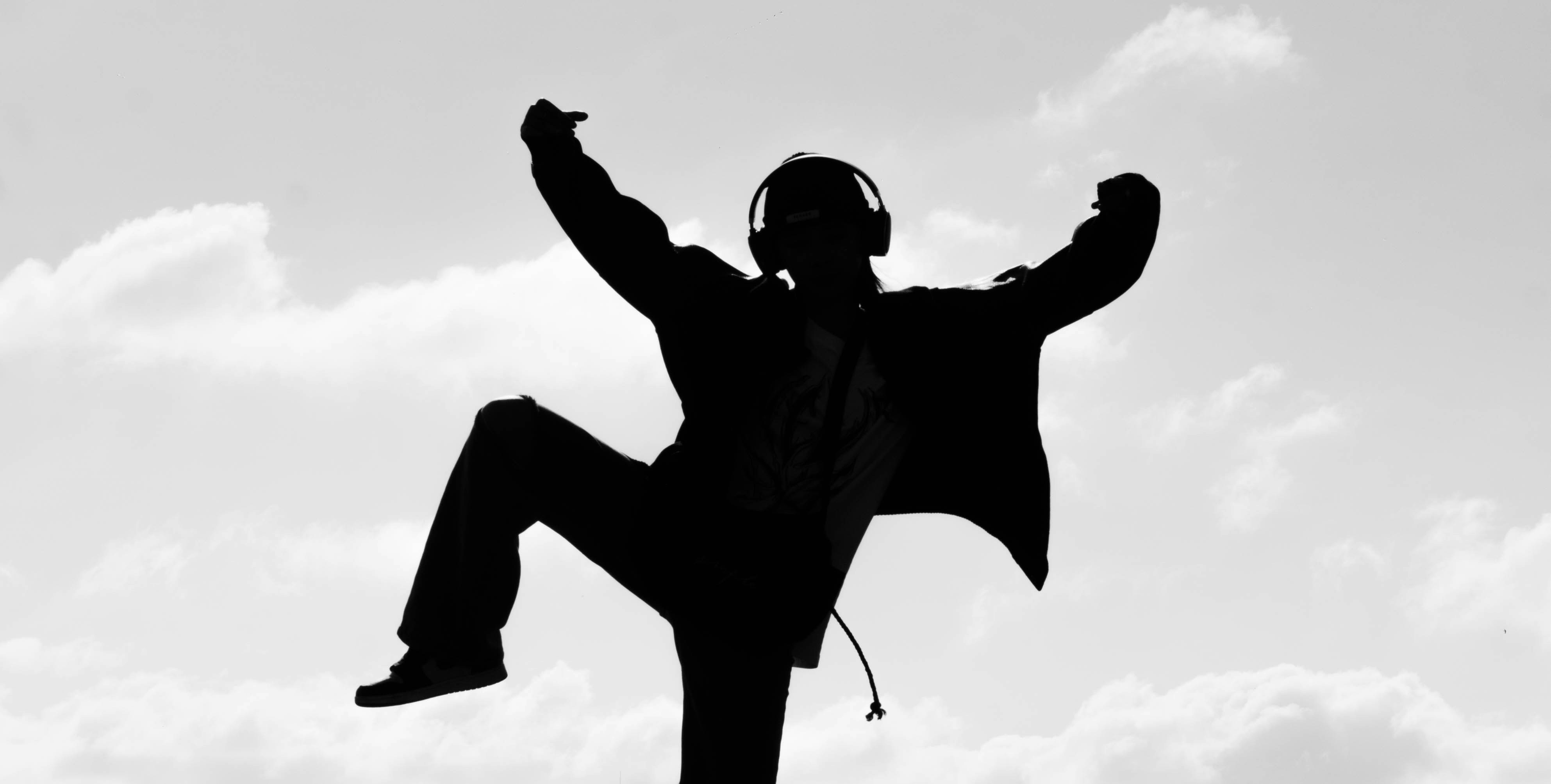 a silhouette of a man in a suit and headphones