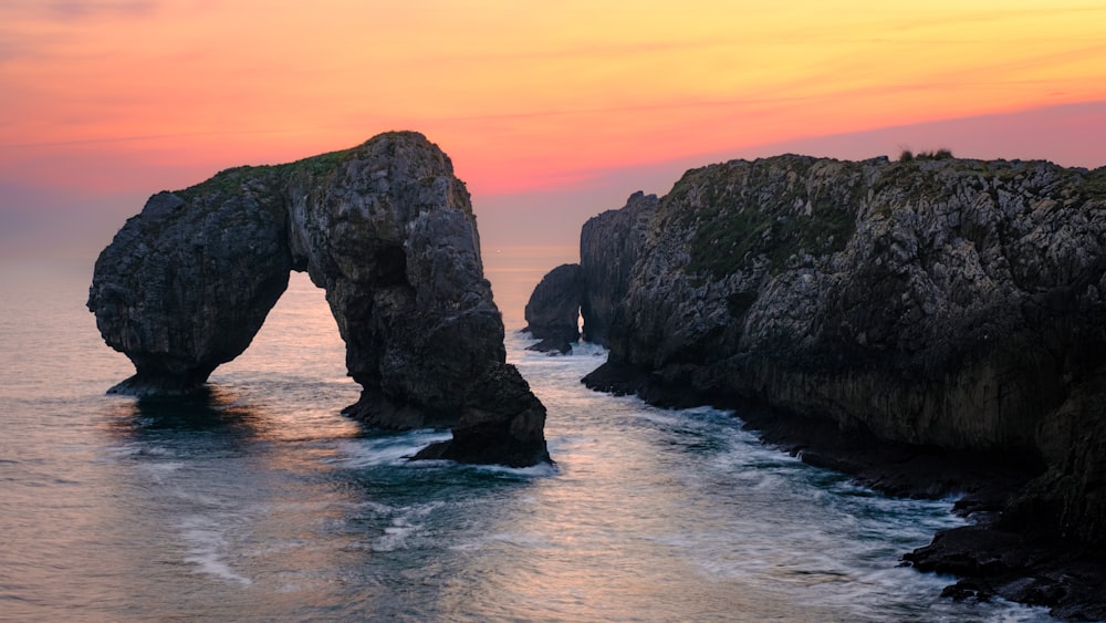 two large rocks sticking out of the ocean