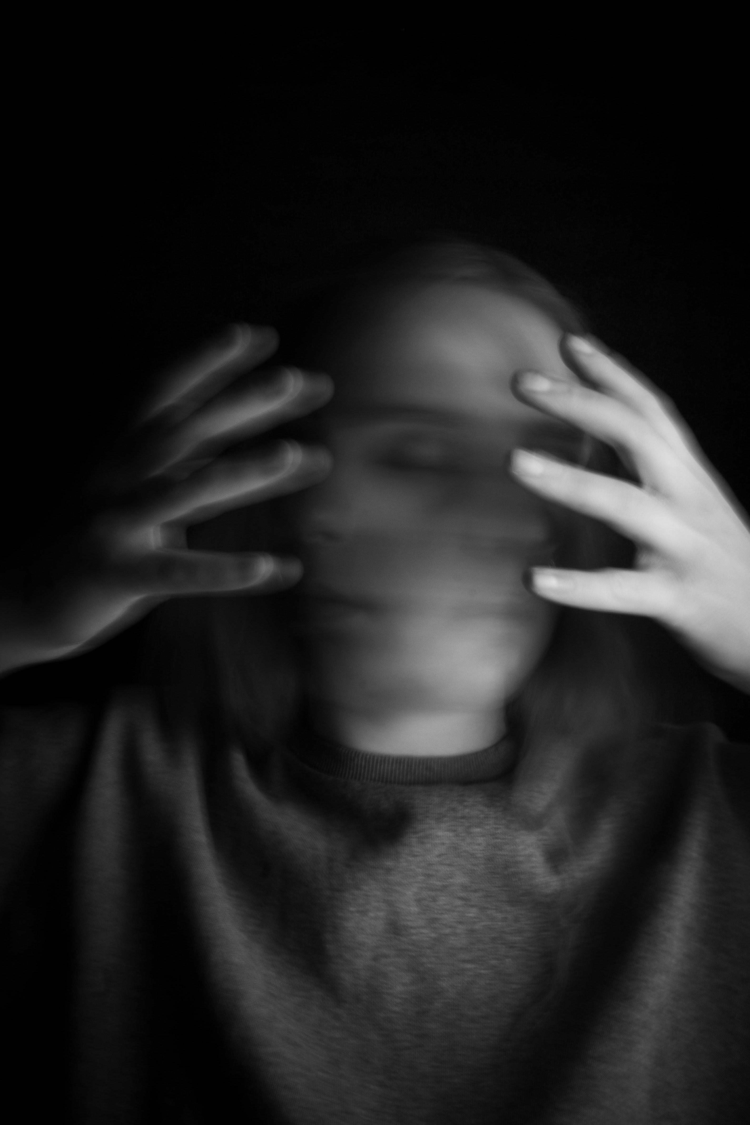 a woman covering her face with her hands