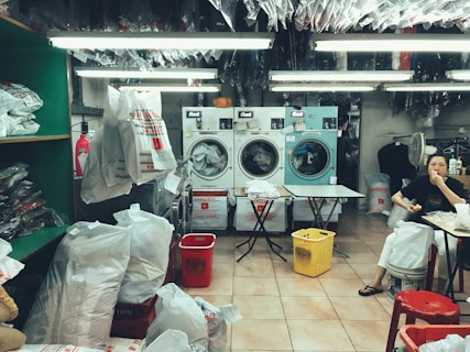 a woman sitting in front of a washing machine
