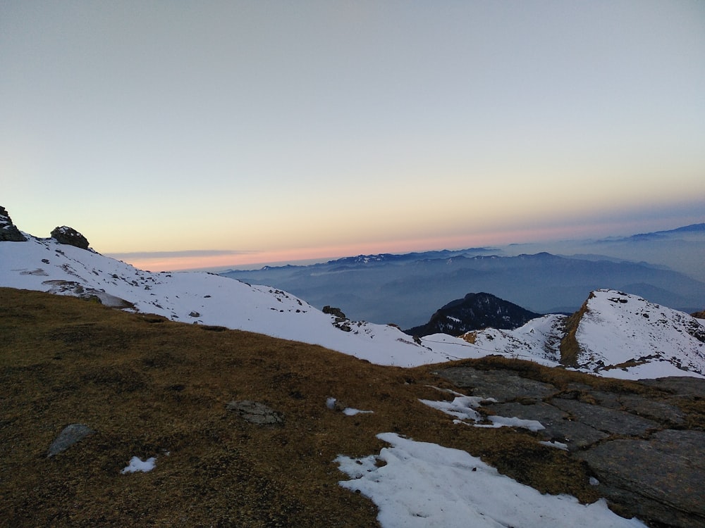 a person standing on top of a snow covered mountain