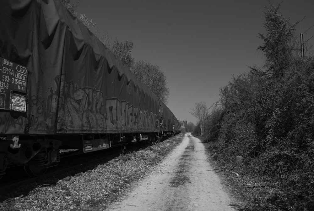 a black and white photo of a train on the tracks