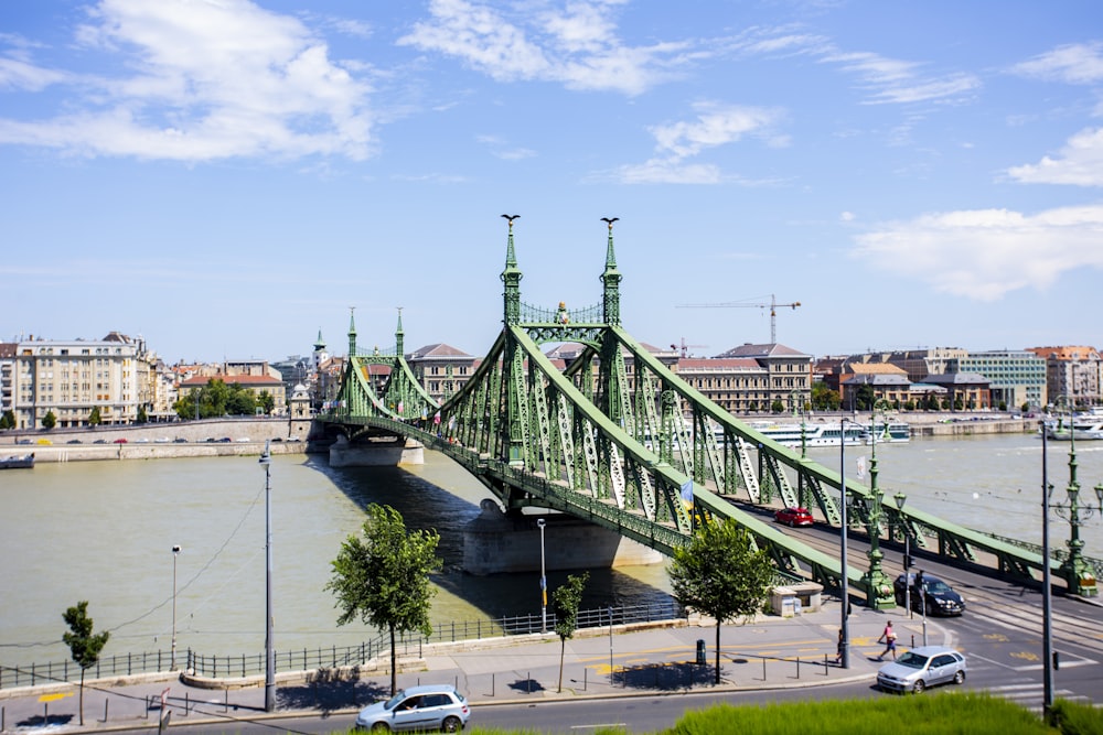 a large bridge spanning over a river next to a city