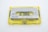 A vintage audio cassette tape with a transparent yellow case and a gray label indicating 'KAMICHI Low Noise High Output' for side B. The cassette tape is labeled with 'LH C90' and features visible reels and spools inside the clear casing.