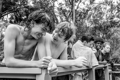 Seniors sharing a laugh poolside, wrapped in towels after a refreshing swimming session.