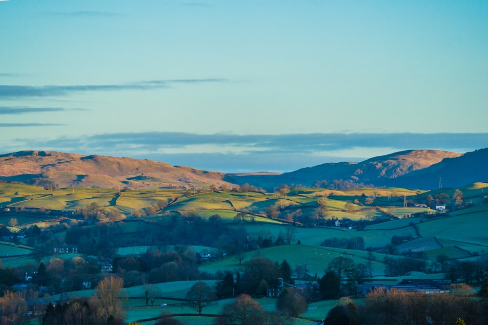 a view of a valley with hills in the background