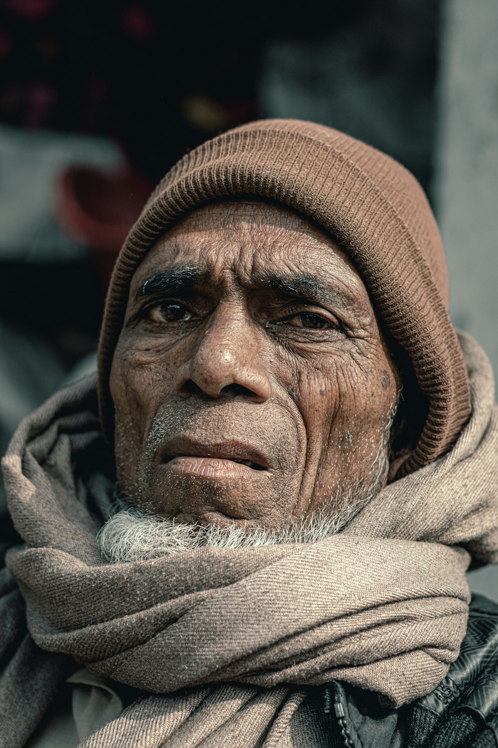 a man wearing a brown hat and scarf