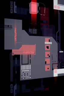 An abstract composition featuring geometric shapes and circuit-like patterns, predominantly in shades of red, black, and gray. The design resembles a futuristic or digital-themed artwork with interconnected elements and glowing effects.