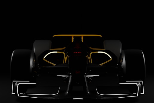 a black and yellow race car in the dark