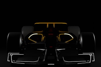 a black and yellow race car in the dark