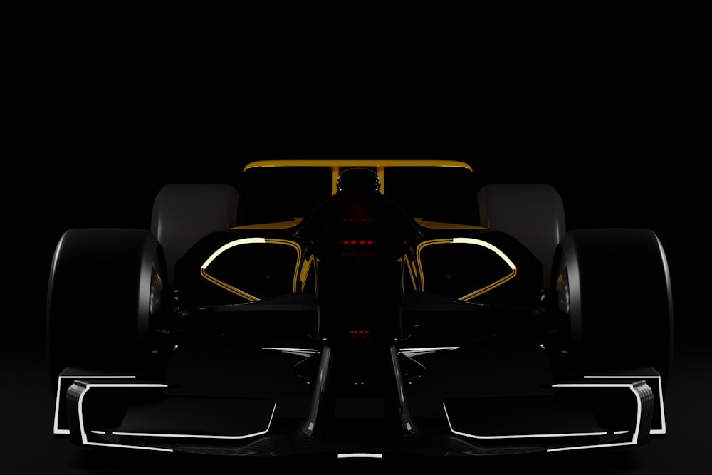 a black and yellow race car in the dark