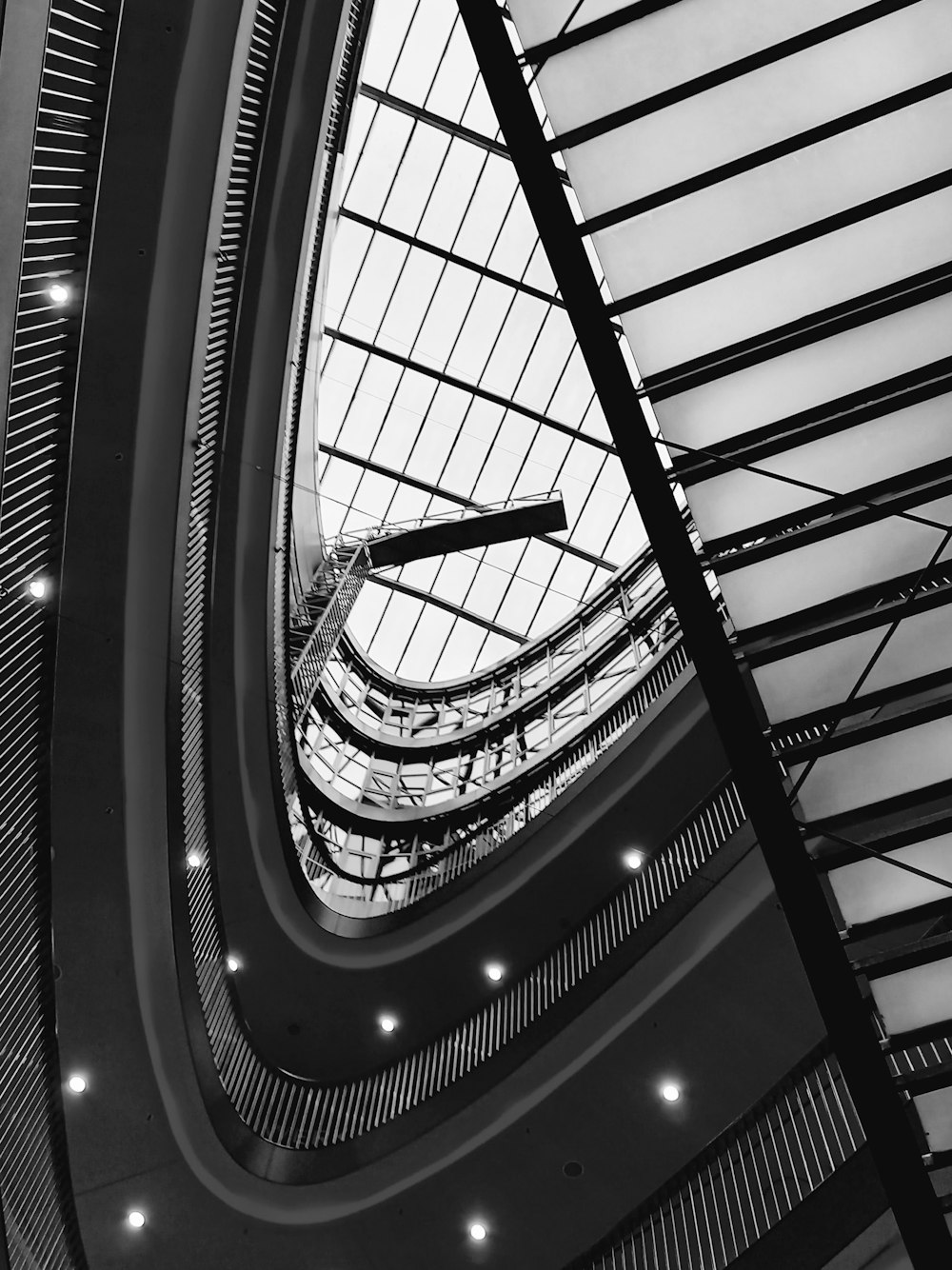 a black and white photo of a clock in a building