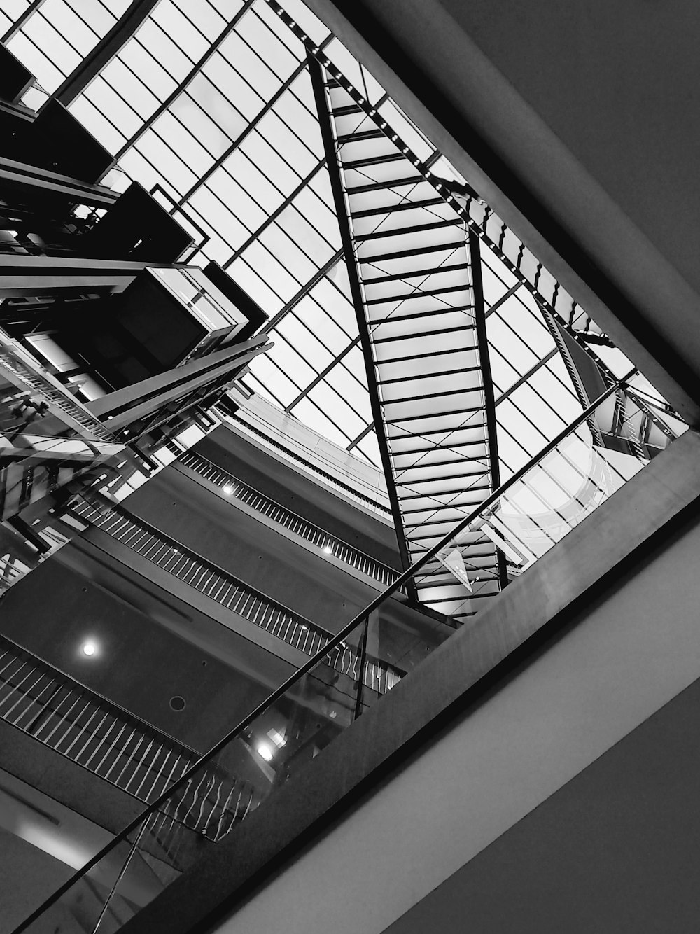 a black and white photo of a staircase in a building