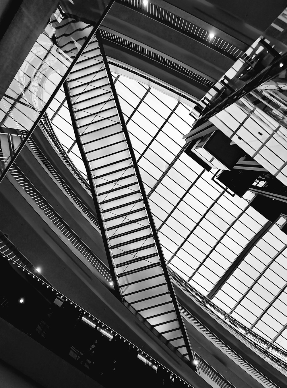 a black and white photo of the ceiling of a building