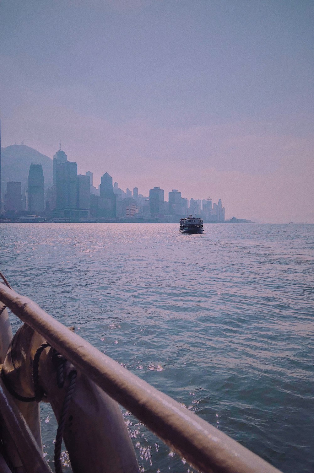 a boat in a body of water with a city in the background