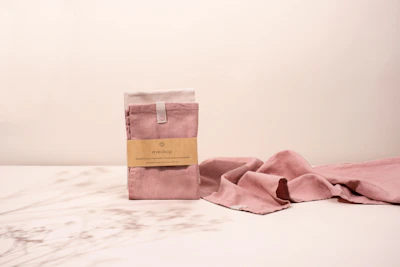 Soft, fluffy bath towels folded on a shelf with a calming blue background.