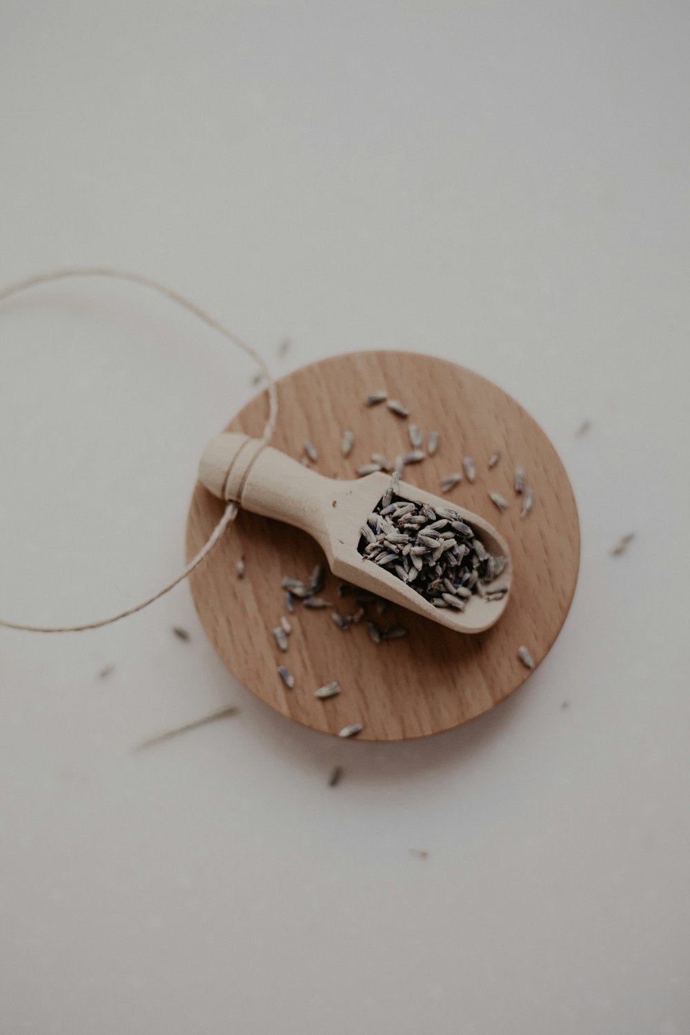 a wooden board topped with a scoop of black seed