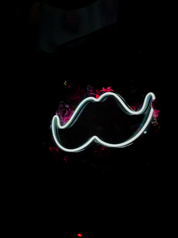 a neon moustache on a black background