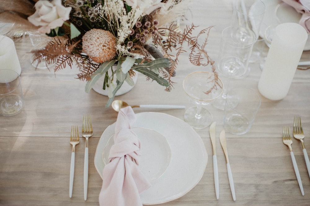 a table set with a white plate and silverware