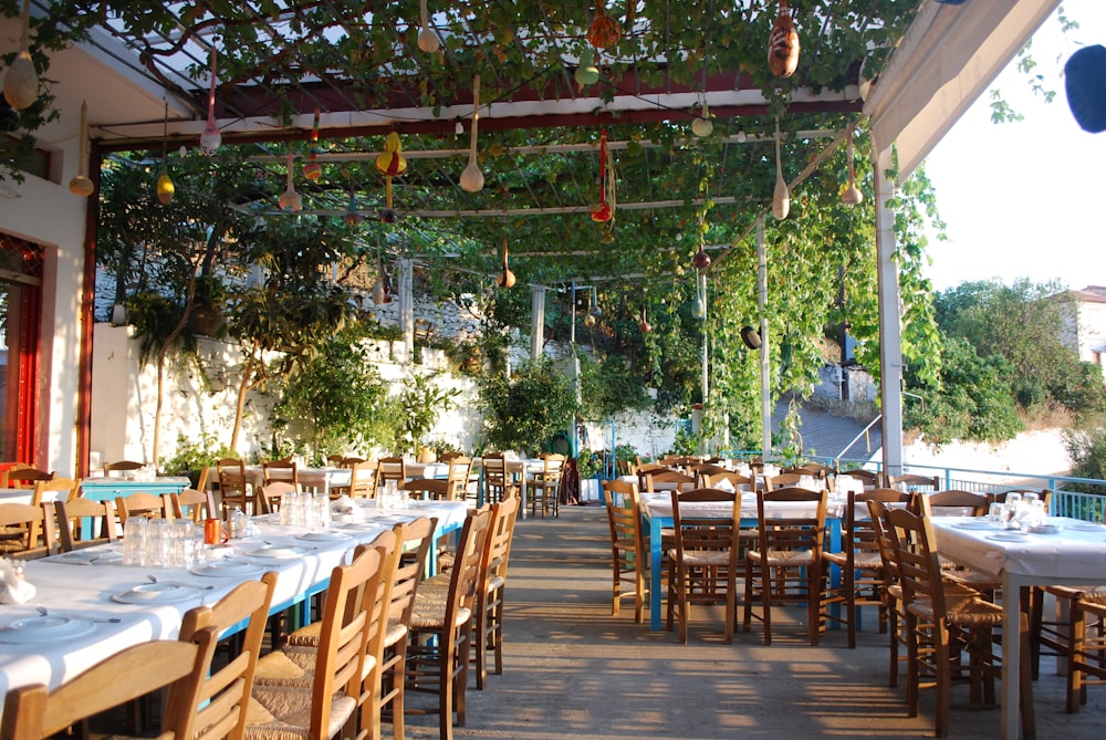 an outdoor dining area with tables and chairs