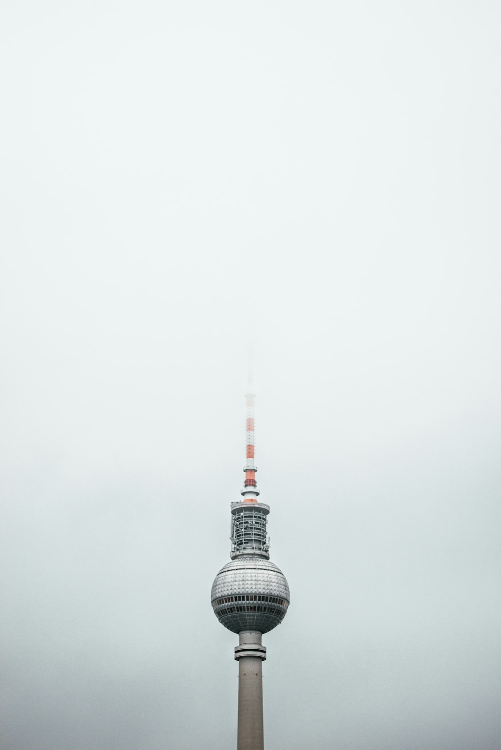 a tall tower with a red and white top