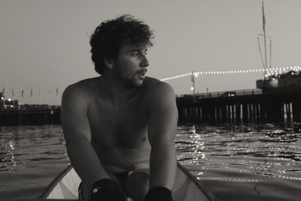 a man sitting in a boat in the water