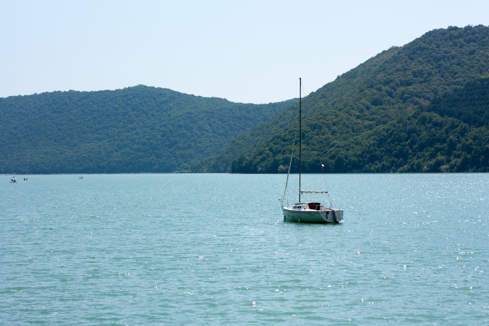 a sailboat floating in the middle of a large body of water