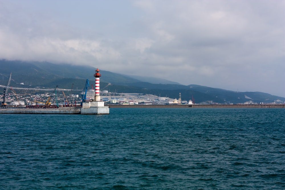 a large body of water with a lighthouse in the middle of it