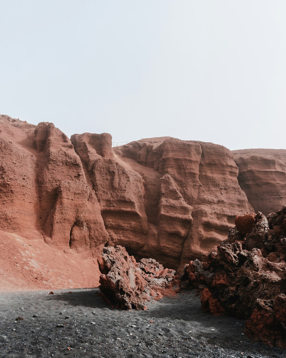 a rocky area with some rocks and a sky background