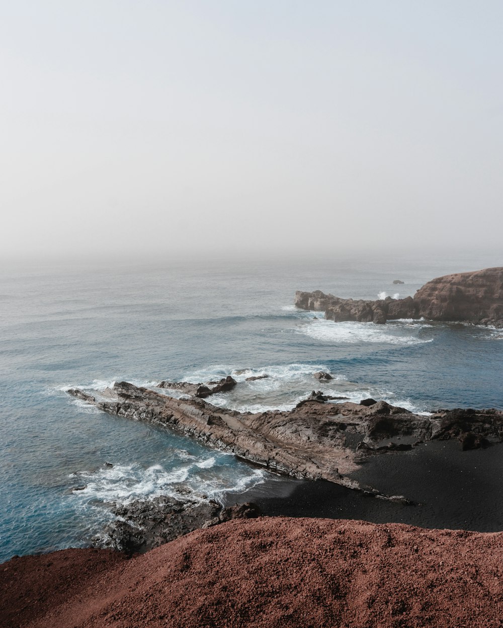 a body of water surrounded by rocky coastline