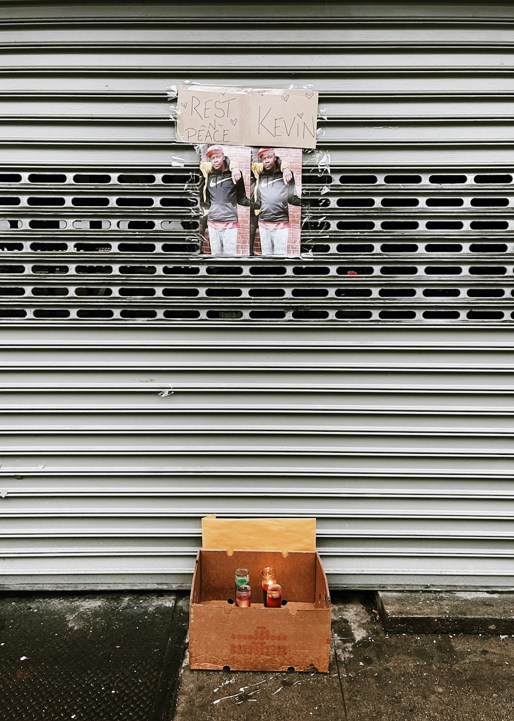 a cardboard box sitting on the side of a building