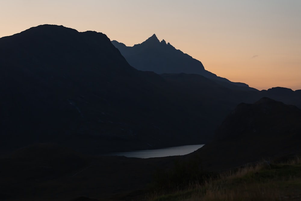 a mountain range with a body of water in the foreground