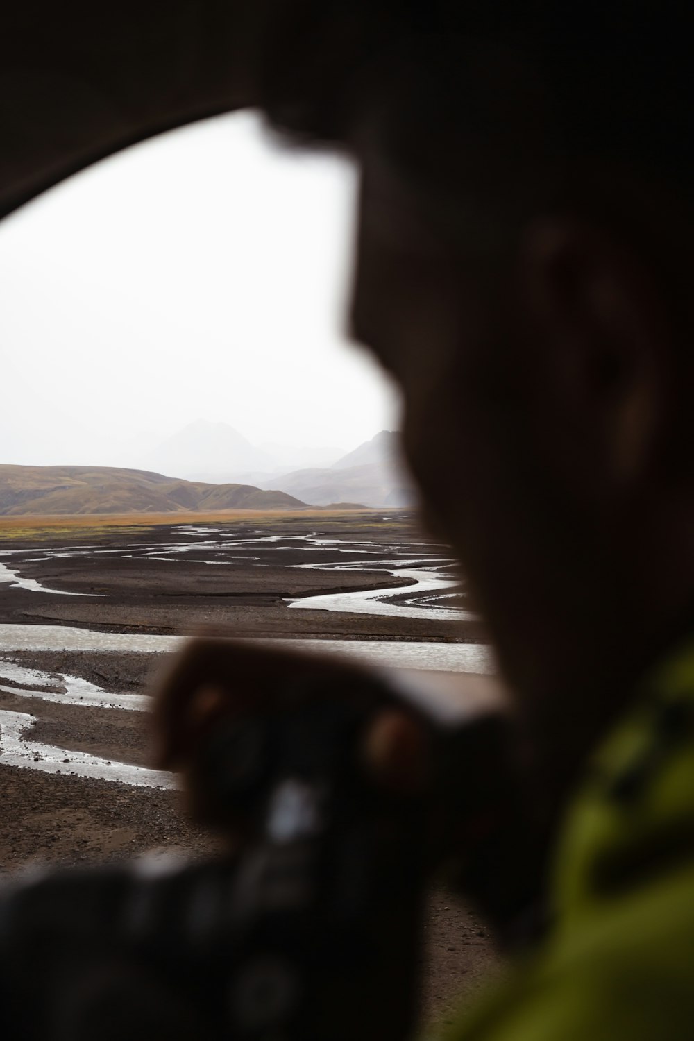 a man is looking out the window of a vehicle