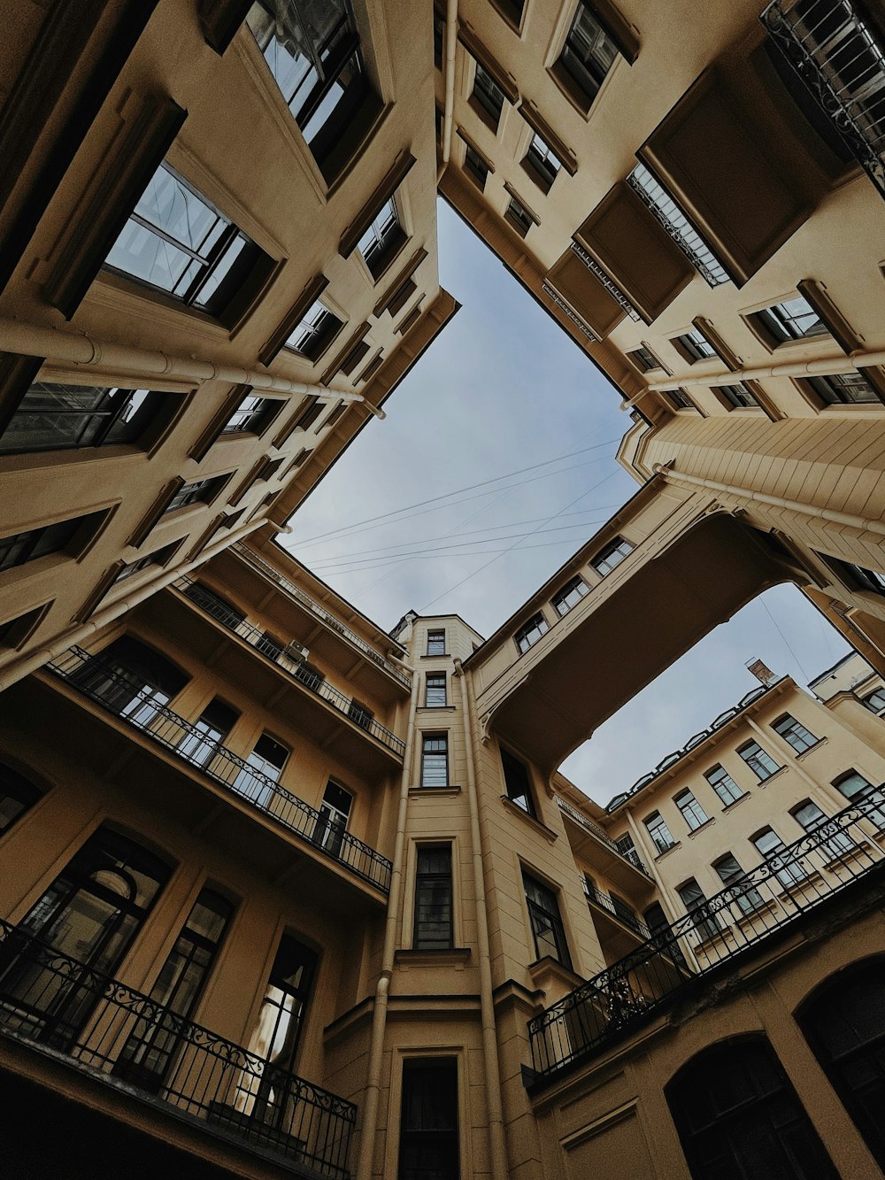 looking up at a tall building with balconies