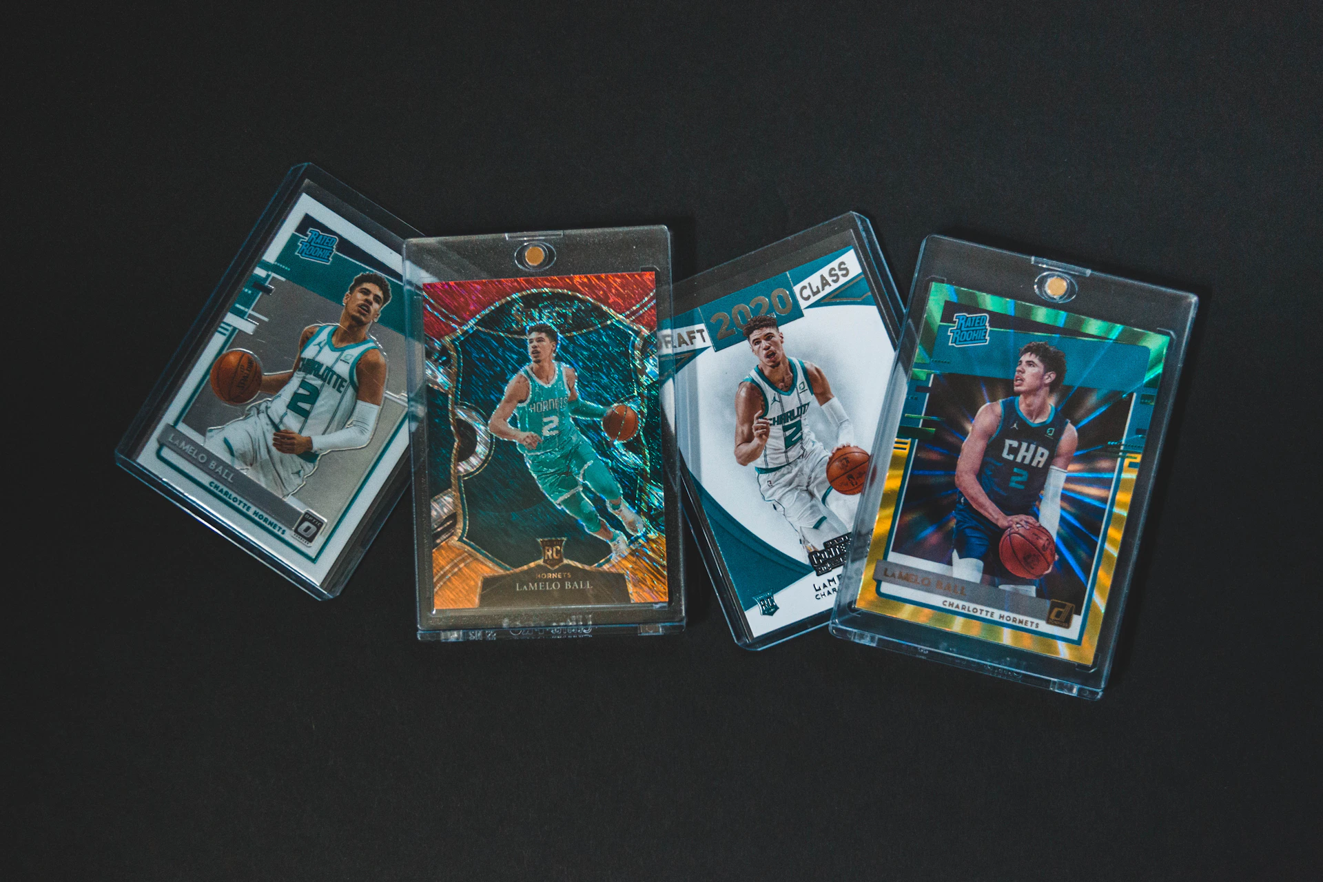a group of three basketball cards sitting on top of a table