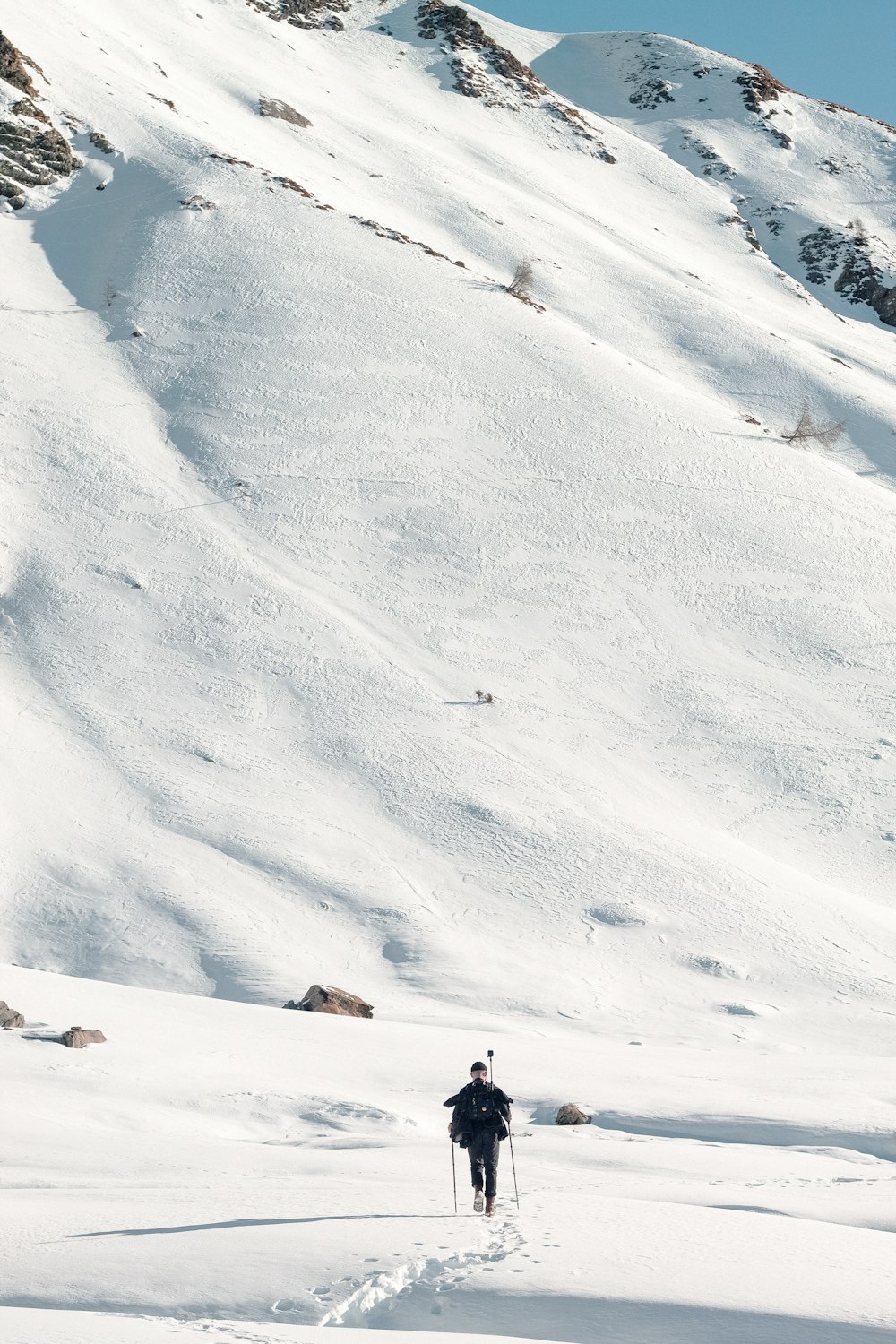 a person walking up a snow covered mountain