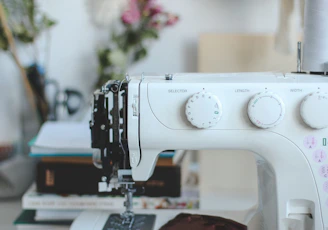 a white sewing machine sitting on top of a table
