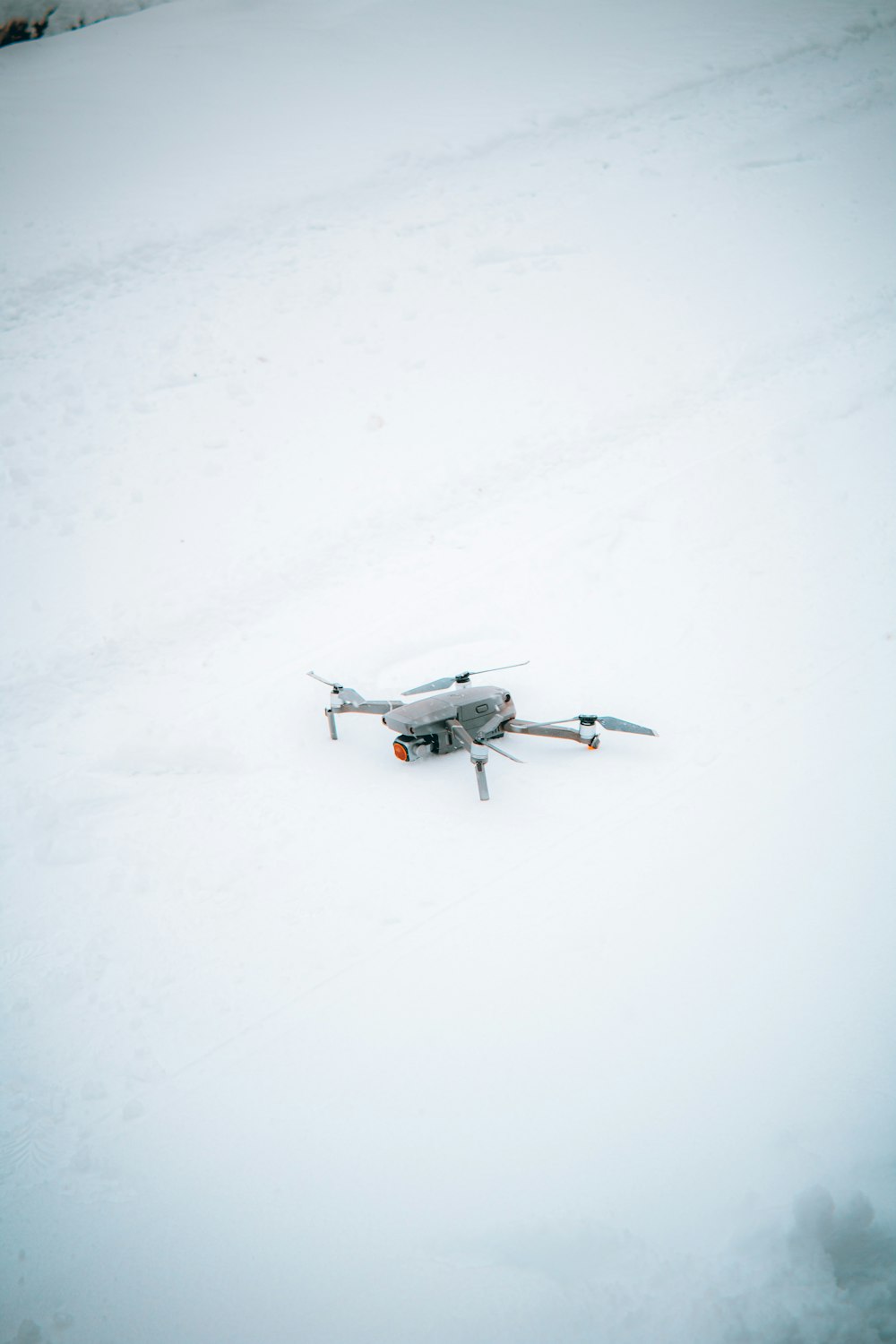 a small airplane sitting on top of a snow covered field