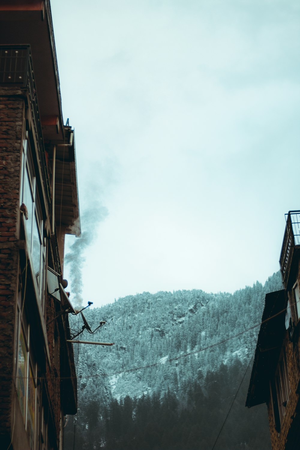 a tall building with a mountain in the background